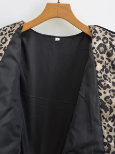 Detail view of the leopard print jacket featuring smooth black satin lining and size S label