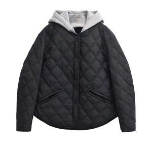 Detail of diamond quilted texture and gray jersey hood on black hooded jacket