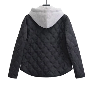 Detail view of the back side of a black quilted diamond pattern hooded puffer jacket