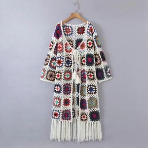 Detail of colorful granny square crochet cardigan with handmade fringe and tassel tie belt
