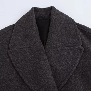 Close-up of deep grey double-breasted lapel and wool blend texture of the coat