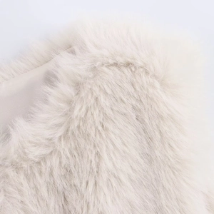 Detail of soft cream faux fur texture with smooth satin lining on a luxury vest