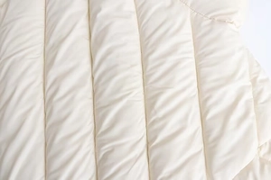 Detail shot of twill quilted padding showing soft material and fluffy texture