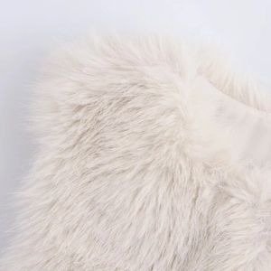 Close-up of white faux fur vest showing soft fluffy texture and high-quality lining