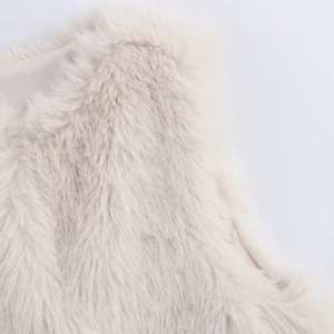 Close-up of plush faux fur texture and smooth silk lining on a white vest