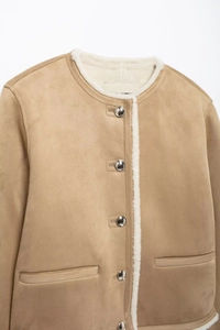 Close-up of camel suede jacket with silver buttons and white faux shearling lining