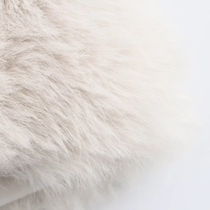 Close-up of the soft white faux fur texture and dense fibers on this sleeveless vest
