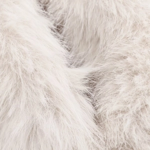 Close-up of premium cream white faux fur texture showing soft fluffy fibers and luxury feel
