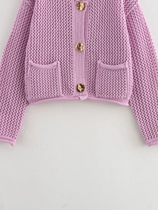 Detail of lavender knit cardigan showing镂空 texture and vintage gold embossed buttons