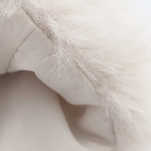 Close-up of the soft faux fur texture and ribbed lining on a white sleeveless vest