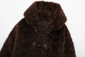 Close-up of deep brown teddy fur coat featuring vintage toggle buttons and wide collar