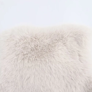Macro shot of high-quality faux fur material showing soft cream texture and long fluffy fibers