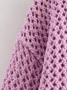 Macro detail of the purple knitted fabric texture and lilac cardigan woven mesh pattern
