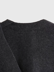 Close-up detail of dark grey knit cardigan showing the fine wool blend collar texture