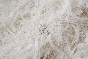 Macro shot of faux fur fabric with silver threads and metallic U-shaped hook closure detail