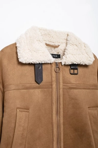 Detail of brown faux suede jacket with creamy shearling collar and metal ring zipper puller