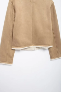 Close-up of camel faux suede jacket with white faux shearling lining and neat stitching