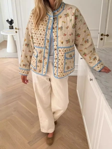 Women's floral quilted jacket with light blue trim and button closure in a loose fit