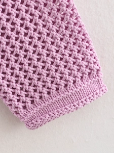 Detail of pink-purple crochet knit cuff with hollow mesh texture and ribbed edges