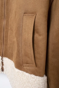 Detailed close-up of brown suede jacket with silver zipper and white faux shearling trim