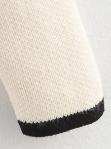 Women's knit cardigan in cream with black contrast trim and soft textured fabric