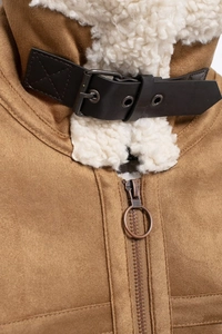 Detail of faux suede jacket collar with white shearling lining and black leather buckle strap