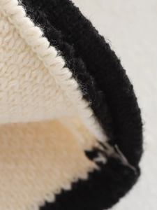 Close-up of contrast black and white knit texture on casual street fashion cardigan