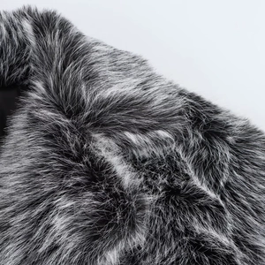 Close-up detail of high-quality black and white faux fur texture on a winter jacket collar
