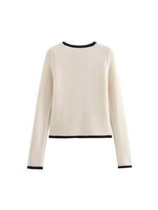 Back view of cream knit cardigan with black contrast trim and waffle texture fabric