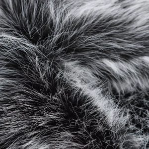 Macro shot of high-quality faux fox fur texture in silver grey showing soft dense fibers