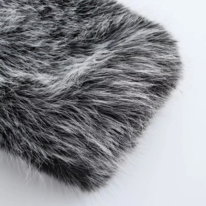Detailed macro shot showing the soft texture of black and white faux fur coat material