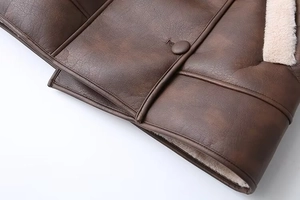 Detailed macro shot of dark brown faux leather jacket with plush shearling lining