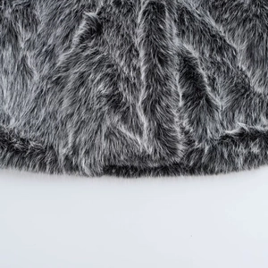 Macro texture of soft grey and black faux fur fabric with fluffy long fibers