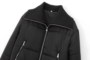 Detail of black puffer jacket showing stand collar with ribbed knit and metal zippers