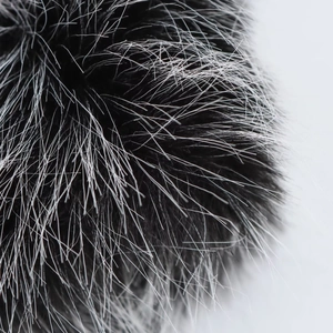 Macro shot of fluffy black and white faux fur texture showing fine fibers and volume
