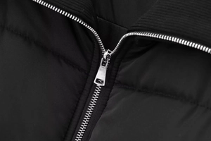 Detail of silver zipper and black ribbed collar on the quilted padded winter jacket