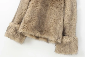 Detail of light brown faux fur texture on sleeve cuffs and hem of the winter pullover