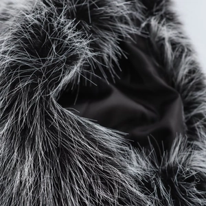 Detail of silver-tipped black faux fur texture with smooth satin lining on collar