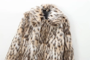 Close-up of fluffy leopard print faux fur jacket showing wide lapels and soft texture