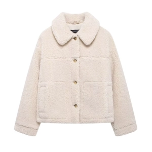 Detail of cream fleece jacket showing lapel collar, amber buttons, and fuzzy texture
