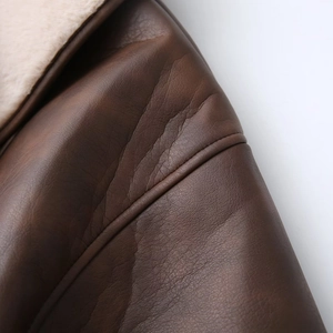 Close-up of faux leather jacket with plush shearling lining and premium stitching details