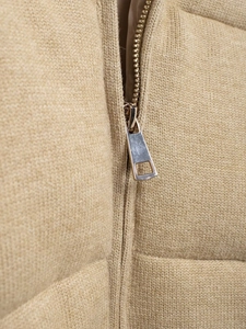 Detailed close-up of premium metal zipper and quilted texture on the khaki winter jacket