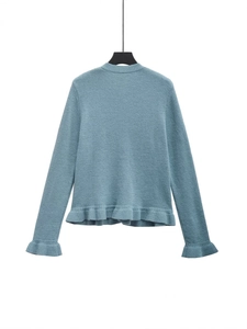 Back view of a blue long sleeve knit cardigan featuring stylish ruffle hem and cuffs
