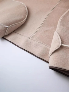 Chic beige faux shearling coat with contrasting brown piping and premium stitching detail