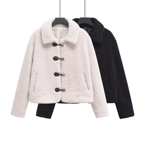 Detail of faux shearling jacket with horn button closures and plush fleece texture