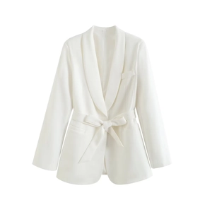 Detail of white blazer featuring an elegant shawl lapel and a waist-slimming bow belt