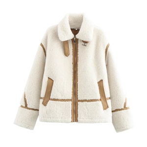 Detail of faux shearling jacket featuring brown leather trim and metal collar buckle