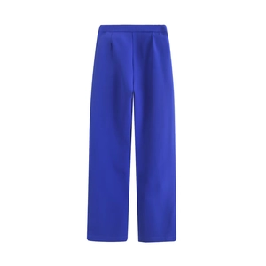 Detail of royal blue high-waisted wide-leg trousers with elegant drape and pleats