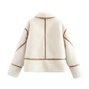 Detail view of the plush faux shearling texture with contrasting brown trim on the jacket