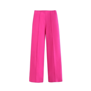 Detail view of fuchsia high waist wide leg trousers with pleated crease design